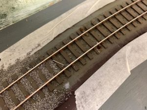 Holding track in place while gluing